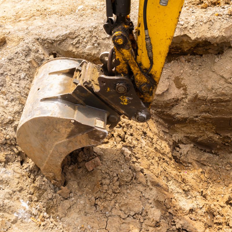 Close,Up,View,Of,An,Excavator,Claw,Scoop,Digging,A